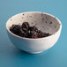 An Elite Global Solutions chocolate chip melamine bowl filled with blackberries.