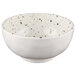A white melamine bowl with black speckled spots.