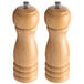 Two Acopa wooden salt and pepper mills with a metal top.