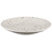 A white Elite Global Solutions round melamine plate with black speckled spots.