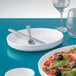 A Villeroy & Boch white porcelain platter with food and a knife on it.
