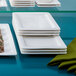 A table with a stack of white Villeroy & Boch Affinity porcelain plates on it.