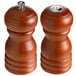 A set of Acopa wooden salt and pepper shakers with brown matte finish and wooden handles.