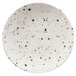 A white Elite Global Solutions round melamine plate with black speckled spots.