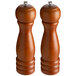 Two Acopa wooden salt and pepper mills.