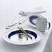 A white and dark blue porcelain bowl with a deep rim and blue accents.