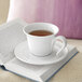 A white Villeroy & Boch Neufchatel porcelain mug of tea on a book.