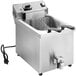 A Vollrath commercial countertop deep fryer with a wire basket handle.