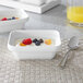 Two white Villeroy & Boch rectangular porcelain bowls filled with yogurt and fruit.