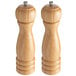 Two Acopa wooden salt and pepper mills with a silver top on a white background.