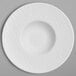 A white porcelain plate with a round center and a circular rim.