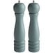Two round grey wooden salt and pepper mills with a silver top.
