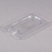 A clear plastic container lid with a spoon notch.