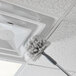 A white Unger SmartColor Telescoping Mop Handle with a brush cleaning the ceiling.