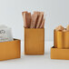 American Metalcraft gold satin stainless steel square sugar packet holders on a hotel buffet counter.
