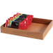 A GET Enterprises Urban Rustic rectangular wood display box with several packages of chocolate bars on a counter.