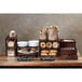 A wooden table with a GET Enterprises walnut square bread box on display with a variety of breads and pastries.