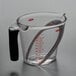 An OXO clear plastic measuring cup with a handle.