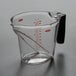 An OXO clear plastic measuring cup with black and red text and a black handle.