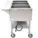 A stainless steel APW Wyott steam table with an undershelf holding food pans.