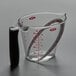A clear OXO measuring cup with a handle.