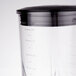 A close-up of a Waring polycarbonate blender jar with lid and blade.