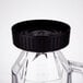 A clear polycarbonate Waring blender jar with a black lid.