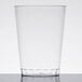 A clear plastic Fineline Savvi Serve tall tumbler on a white surface.