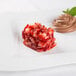 A rectangle stainless steel mold with a strawberry dessert on a white plate.