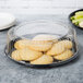 A WNA Comet black round catering tray with cookies and celery on it.