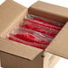 A box filled with plastic bags of Swedish Fish candy.