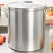 A Vollrath Wear-Ever aluminum pot cover on a large pot on a counter.