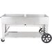 A large stainless steel Crown Verity BBQ grill on wheels.