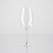An Arcoroc clear wine glass on a reflective surface.