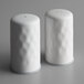 Two white hammered finish salt and pepper shakers.