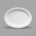 A white oval Elite Global Solutions melamine platter on a gray surface.