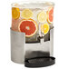 A Rosseto clear acrylic beverage dispenser with fruit slices in it.