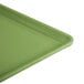A lime green Cambro dietary tray with a corner handle.
