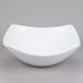 An American Metalcraft white stoneware bowl with a curved edge.