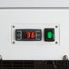 The digital display panel on a white Avantco refrigerated bakery case with a green light
