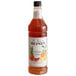 A bottle of Monin Premium Winter Citrus flavoring syrup with a label.