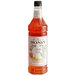 A bottle of Monin Candy Corn flavoring syrup with an orange and white label.