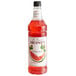 A bottle of Monin watermelon syrup with a red label.