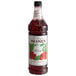 A Monin Premium Hibiscus flavoring syrup bottle with a label.