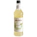 A white Monin bottle of yellow liquid labeled "Monin Premium Lemongrass Flavoring Syrup"