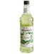 A white Monin bottle of cucumber flavoring syrup with a label.