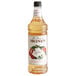 A bottle of Monin Premium Lychee Flavoring Syrup with a label.