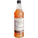 A bottle of Monin Premium Zero Calorie Natural Peach Flavoring Syrup on a white background.