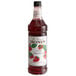 A bottle of Monin Premium Wild Strawberry Flavoring Syrup with a label.
