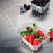A plastic container with strawberries and blackberries inside a Pactiv clear clamshell container.